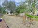 Spacious backyard with a lawn, trees, and privacy fence at 7504 Turtle View Dr, Ruskin, FL 33573