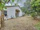 Backyard with mature trees and landscaping around the perimeter at 7504 Turtle View Dr, Ruskin, FL 33573