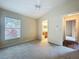 Neutral carpeted bedroom with ensuite bath and natural light, offering comfort and convenience at 7504 Turtle View Dr, Ruskin, FL 33573