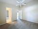 Neutral bedroom featuring carpet, ceiling fan, access to bathroom and other rooms at 7504 Turtle View Dr, Ruskin, FL 33573