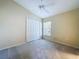 Neutral bedroom with carpet, ceiling fan, window with blinds and closet with double doors at 7504 Turtle View Dr, Ruskin, FL 33573