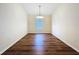 Dining room with wood floors, a charming chandelier, and ample natural light at 7504 Turtle View Dr, Ruskin, FL 33573