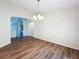 Spacious dining room with wood floors and view to the kitchen at 7504 Turtle View Dr, Ruskin, FL 33573
