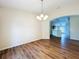 Dining room boasts hardwood floors and modern chandelier, blending elegance and comfort at 7504 Turtle View Dr, Ruskin, FL 33573