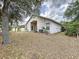Exterior view of the home highlighting the backyard with an AC unit at 7504 Turtle View Dr, Ruskin, FL 33573