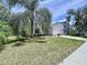Charming single-Gathering home with a two-car garage and mature trees on a lush, green lawn at 7504 Turtle View Dr, Ruskin, FL 33573
