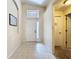 Bright foyer featuring tiled flooring, a transom window, and a white front door at 7504 Turtle View Dr, Ruskin, FL 33573