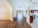 Spacious living room with laminate floors seamlessly connecting to an open kitchen layout at 7504 Turtle View Dr, Ruskin, FL 33573