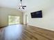 Bright living room features vaulted ceilings, wood floors, and sliding doors to the backyard at 7504 Turtle View Dr, Ruskin, FL 33573