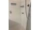 Modern walk-in shower with white tile and convenient corner shelves for toiletries at 7504 Turtle View Dr, Ruskin, FL 33573