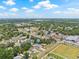 Scenic aerial view shows the home surrounded by lush greenery and a vibrant neighborhood under a bright sky at 7612 S 36Th Ave, Tampa, FL 33619