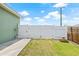 Well-maintained backyard featuring a grass lawn and a white privacy fence at 7612 S 36Th Ave, Tampa, FL 33619