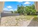 Spacious backyard with a wooden fence, lush trees, and a storage shed at 7612 S 36Th Ave, Tampa, FL 33619