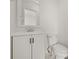White vanity and toilet in bathroom, paired with modern fixtures and tiled floors at 7612 S 36Th Ave, Tampa, FL 33619