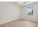 A bright, empty bedroom with a single window, light wood floors and neutral paint at 7612 S 36Th Ave, Tampa, FL 33619