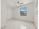 Bright bedroom with tiled floors, a ceiling fan, and a window with a view at 7612 S 36Th Ave, Tampa, FL 33619