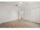 Bright bedroom featuring light-colored wood floors and double door closets at 7612 S 36Th Ave, Tampa, FL 33619