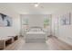 Serene bedroom featuring a plush bed, soft lighting, and light wood floors that create a calm retreat at 7612 S 36Th Ave, Tampa, FL 33619