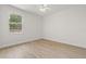 An empty bedroom with light wood floors and a sun-lit window at 7612 S 36Th Ave, Tampa, FL 33619