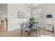 Modern dining room with a glass table, stylish chairs, modern art, and bright natural light at 7612 S 36Th Ave, Tampa, FL 33619
