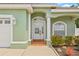 Close up front exterior featuring a well maintained lawn, beautiful plants and lovely front door at 7612 S 36Th Ave, Tampa, FL 33619