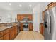 Open concept kitchen featuring stainless steel appliances and wood cabinetry at 7612 S 36Th Ave, Tampa, FL 33619