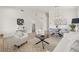 Open-concept living room and dining room featuring wood laminate flooring and neutral color scheme at 7612 S 36Th Ave, Tampa, FL 33619