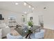Bright, open-concept living and dining area with modern light fixtures and neutral decor for a spacious feel at 7612 S 36Th Ave, Tampa, FL 33619