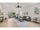 Bright living room with contemporary furniture, ceiling fan, and sliding glass doors at 7612 S 36Th Ave, Tampa, FL 33619