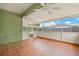 Enclosed patio with ceiling fans, views of fenced yard, and tile flooring at 7612 S 36Th Ave, Tampa, FL 33619