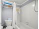 Clean bathroom features a white tiled shower and tub combination with updated fixtures at 7701 Starkey Rd # 332, Seminole, FL 33777