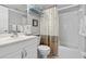 Bright bathroom featuring a shower-tub combo, white vanity and neutral color palette at 7701 Starkey Rd # 332, Seminole, FL 33777