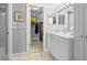 Bathroom featuring a double vanity, a tile floor, and a walk-in closet at 7701 Starkey Rd # 332, Seminole, FL 33777