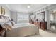 Large bedroom featuring neutral walls, a comfortable bed, and a dresser with a mirror at 7701 Starkey Rd # 332, Seminole, FL 33777