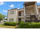 Two-story condo building exterior with landscaped bushes and entryways at 7701 Starkey Rd # 332, Seminole, FL 33777