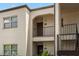 Close up of a two-story condo building exterior with arched entryways and stairwell at 7701 Starkey Rd # 332, Seminole, FL 33777
