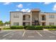 Well-maintained condo building exterior with assigned parking and tidy landscaping at 7701 Starkey Rd # 332, Seminole, FL 33777