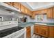 Kitchen with a view to the living area, tile floors, and wood cabinets at 7701 Starkey Rd # 332, Seminole, FL 33777