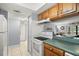 Kitchen with a breakfast bar, appliances, and tile floors at 7701 Starkey Rd # 332, Seminole, FL 33777