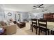 Living room featuring a sofa, wood table, neutral tile floors and mirrored wall with view to dining area at 7701 Starkey Rd # 332, Seminole, FL 33777