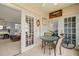 Relaxing patio with a small glass table, chairs, with view to living and kitchen area at 7701 Starkey Rd # 332, Seminole, FL 33777