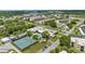 Aerial view of the community highlighting lush landscaping, tennis courts, pool, and multiple residential buildings at 7951 58Th N Ave # 106, St Petersburg, FL 33709