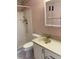 Bathroom featuring a tiled shower with shower wand and a vanity sink and mirror at 7941 58Th N Ave # 106, St Petersburg, FL 33709