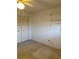 Bedroom featuring double-door closet, carpeted floors, ceiling fan, and white walls at 7941 58Th N Ave # 106, St Petersburg, FL 33709
