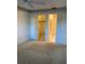 Bedroom featuring a closet and view into a bathroom with neutral carpet and light colored walls at 7951 58Th N Ave # 106, St Petersburg, FL 33709
