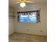 Bedroom with window, shelves, neutral carpet, and overhead fan with light at 7941 58Th N Ave # 106, St Petersburg, FL 33709