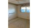 Bedroom with a window, grab bar, floral wallpaper trim, and carpeted floors at 7941 58Th N Ave # 106, St Petersburg, FL 33709