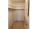 Spacious walk-in closet featuring wire shelving, rod for hanging clothes, and metal grab bar at 7941 58Th N Ave # 106, St Petersburg, FL 33709