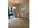 Bright dining room featuring neutral carpet, chandelier, and sliding glass doors to the enclosed lanai at 7941 58Th N Ave # 106, St Petersburg, FL 33709