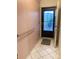 Entryway with pink walls, a safety bar, and a dark colored front door at 7951 58Th N Ave # 106, St Petersburg, FL 33709